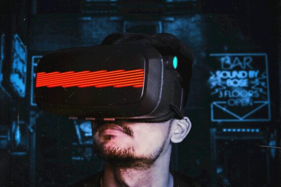 Young man immersed in a virtual reality experience using a VR headset, showcasing futuristic tech in a gaming environment.